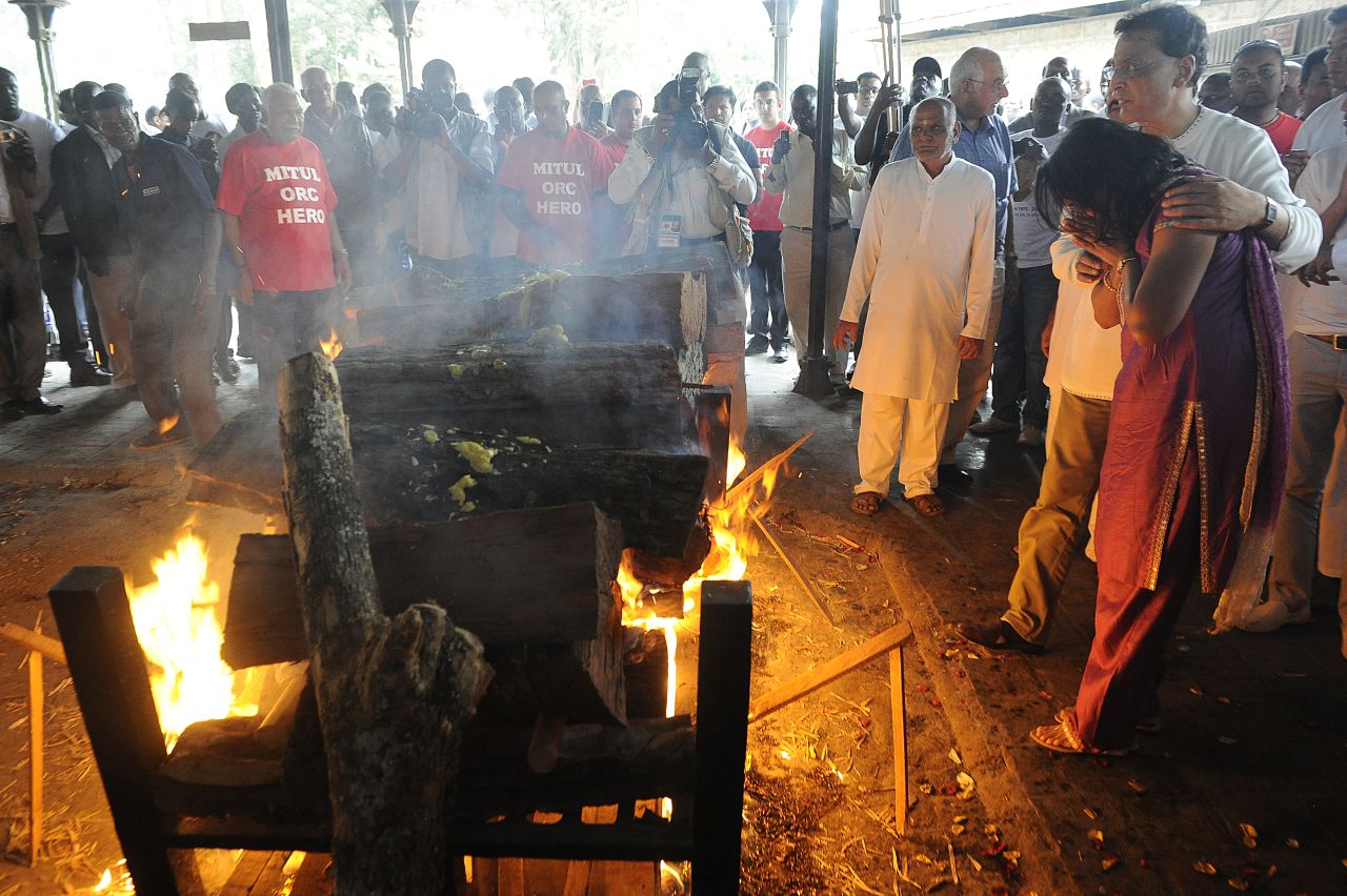 Family members light a funeral pyre at the Sikh funeral of Mitul Shah, the president of a football team in Kenya, in Nairobi on September 26.