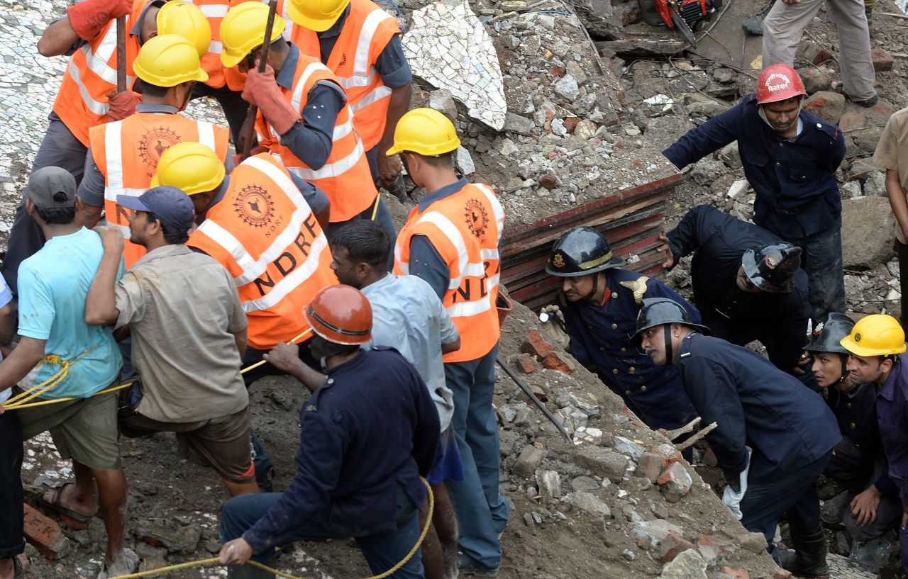 Firefighters look through a gap in the rubble as they search for survivors on September 27.