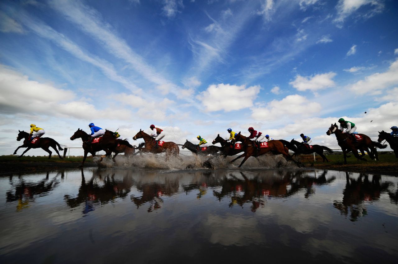 <strong>Punchestown, Ireland: </strong>Runners make their way through "Joe's Water Splash'"at Punchestown racecourse in April. 