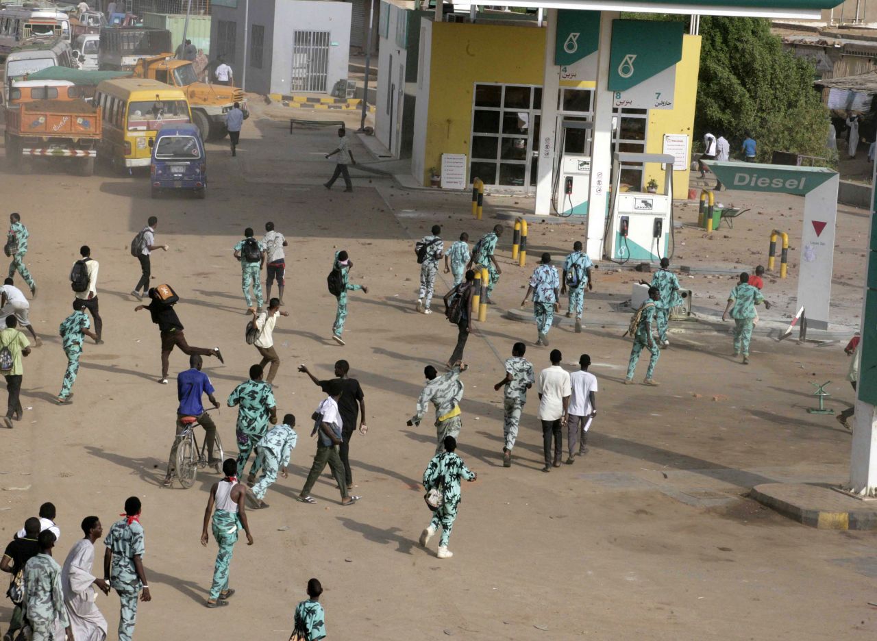 Sudanese protesters throw stones at a gas station in Khartoum's twin city of Omdurman on Wednesday. Sudan is among the countries where political violence continues to increase, Maplecroft said.