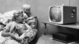 A family watching television in their home, circa 1955.