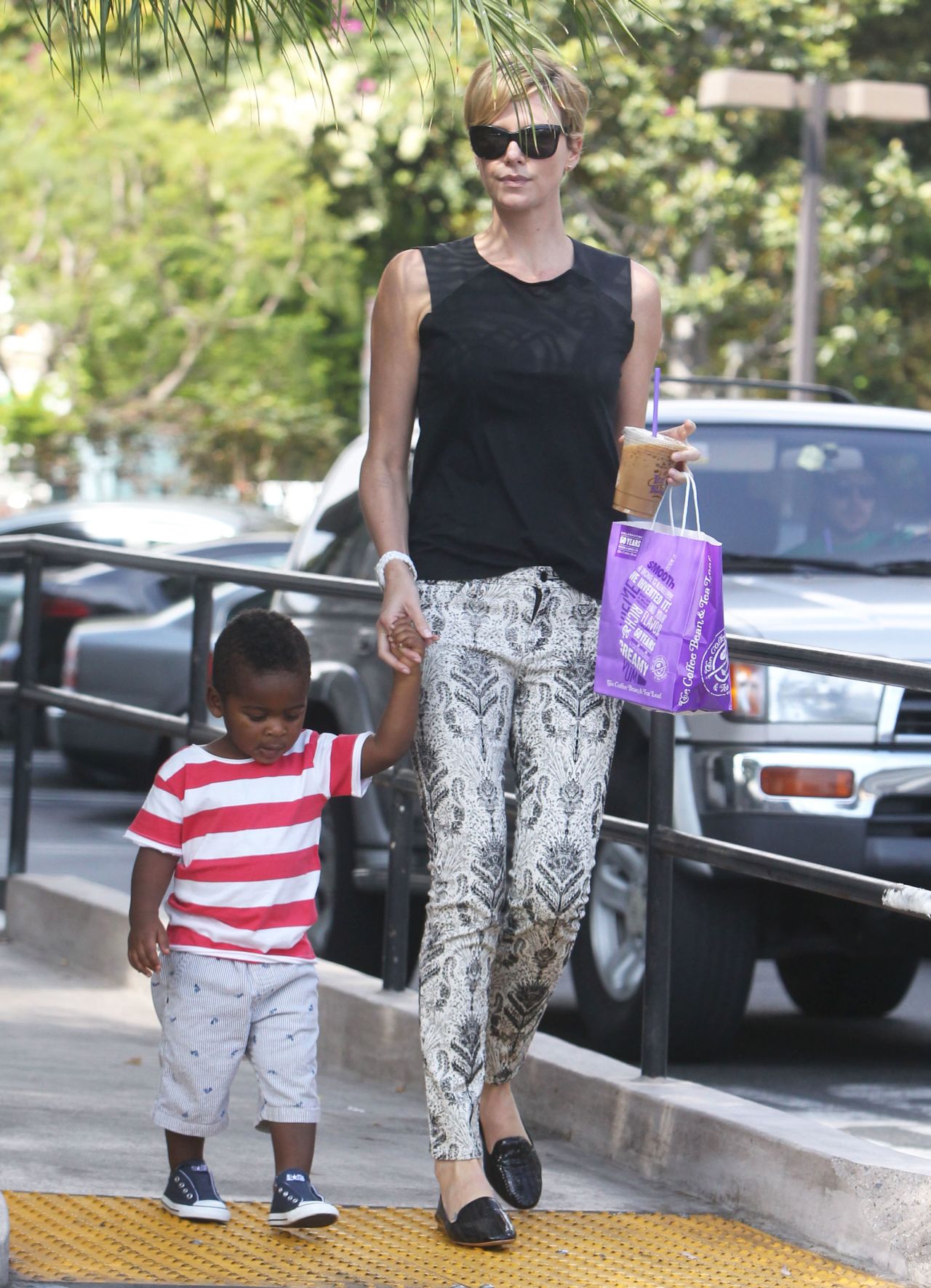 Charlize Theron and her son take a stroll after shopping on September 25.