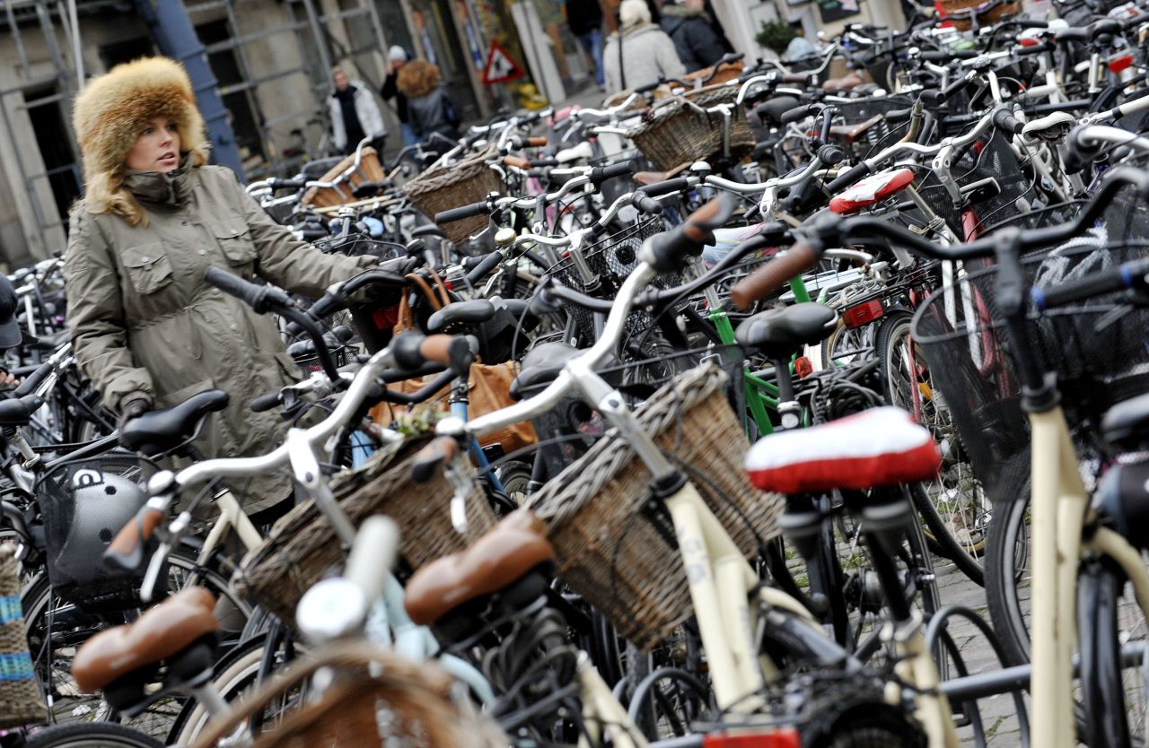 Don't be fooled by these stationary bicycles -- they're just resting. More than half of the city's population cycle to work and compete with cars not only in numbers but speed. Pedestrians beware -- or get on a bike.