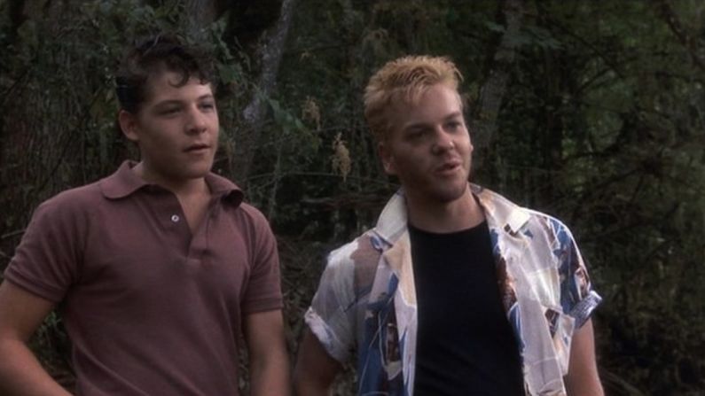Kiefer Sutherland, right, plays Ace Merrill, an older townie who gives the kids of the movie "Stand By Me" something else to fear as they go in search of a body.
