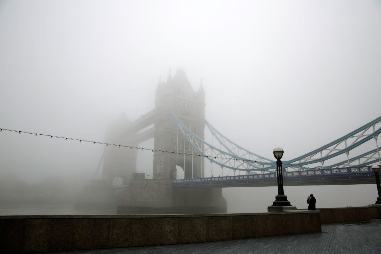 Early morning fog enshrouds the Tower Bridge on September 24 in London. 
