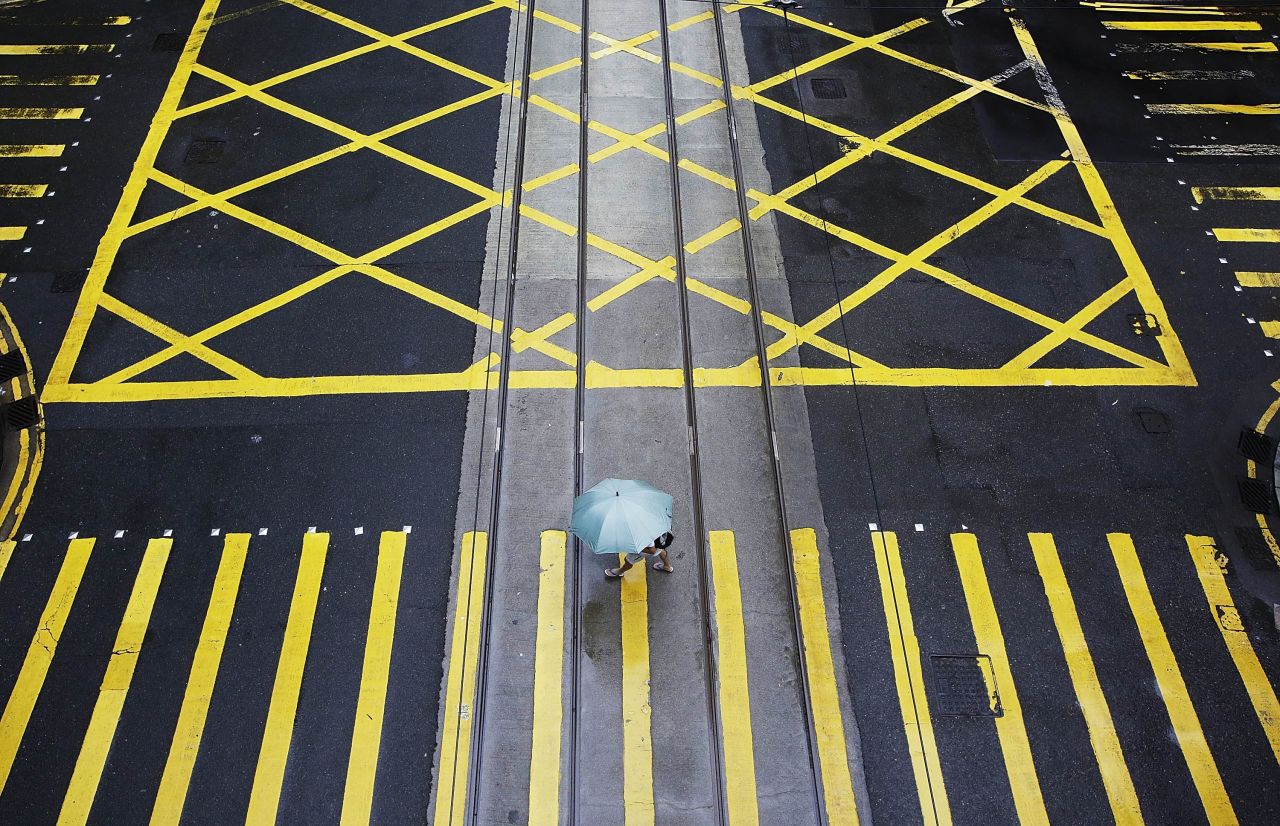 A pedestrian crosses Des Voeux Road in Hong Kong on Monday, September 23 as residents brace for Typhoon Usagi.
