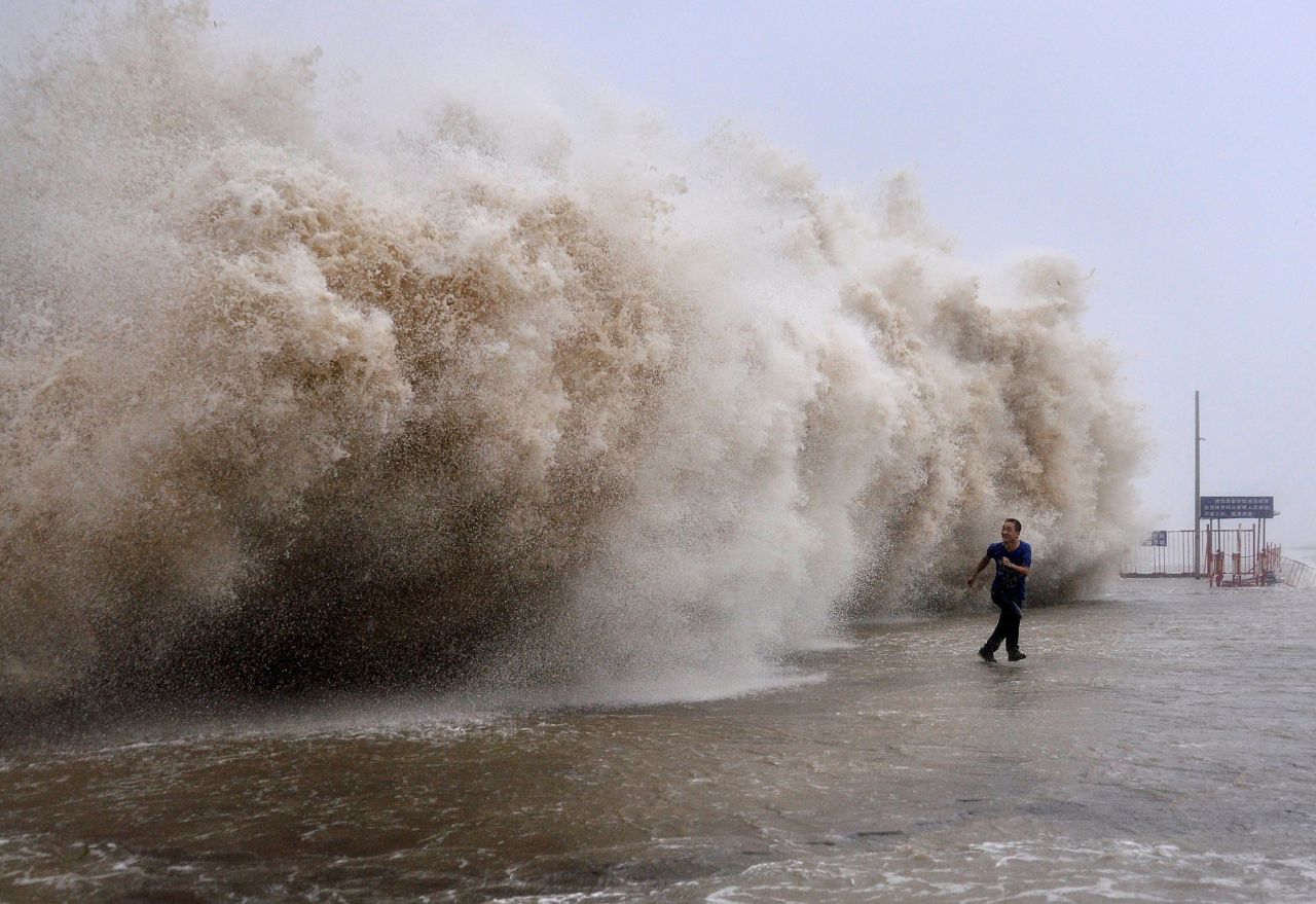 A man runs away from a huge wave generated by Typhoon Usagi on a wharf in Shantou, China, on Sunday, September 22.
