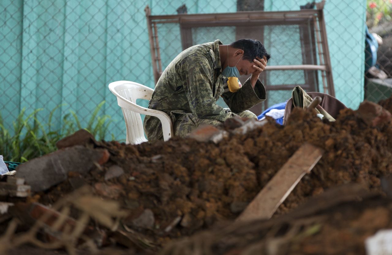 A soldier takes a break during the search for bodies at the site of a landslide in La Pintada, Mexico, on September 22.