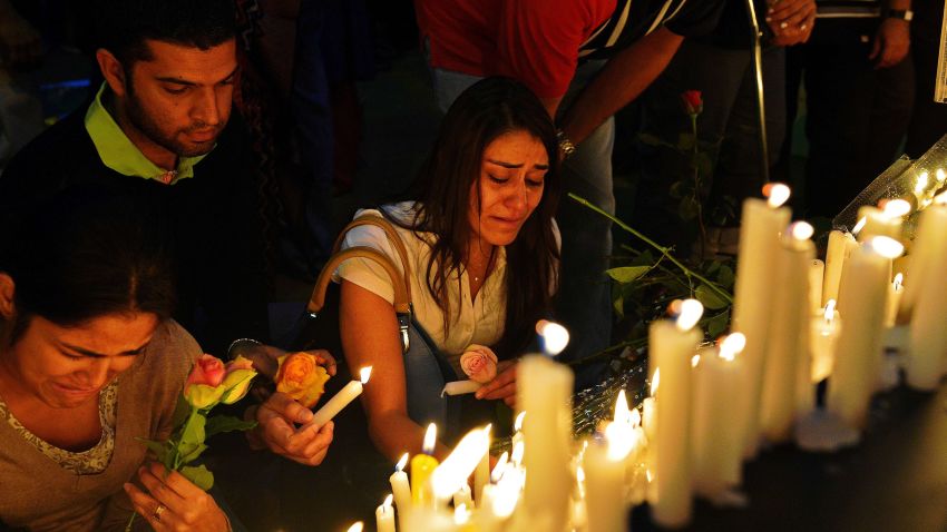  A woman cries as she lights a candle during a 24 hour prayer vigil for victims of the Westgate mall massacre near the Westgate Mall on September 28, 2013.