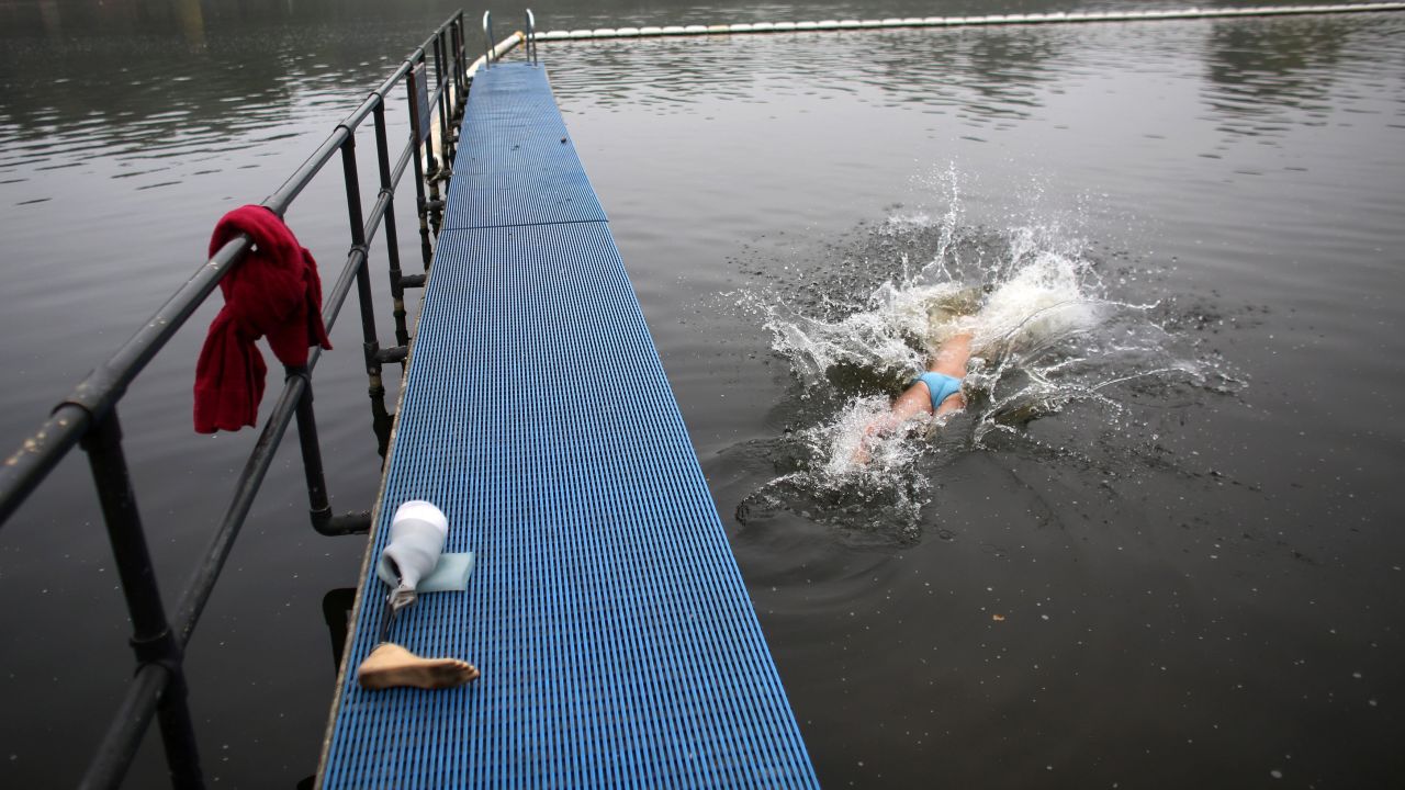 An early morning swimmer leaves his prosthetic leg on the jetty as he dives into the Serpentine lake in Hyde Park in London on September 25.