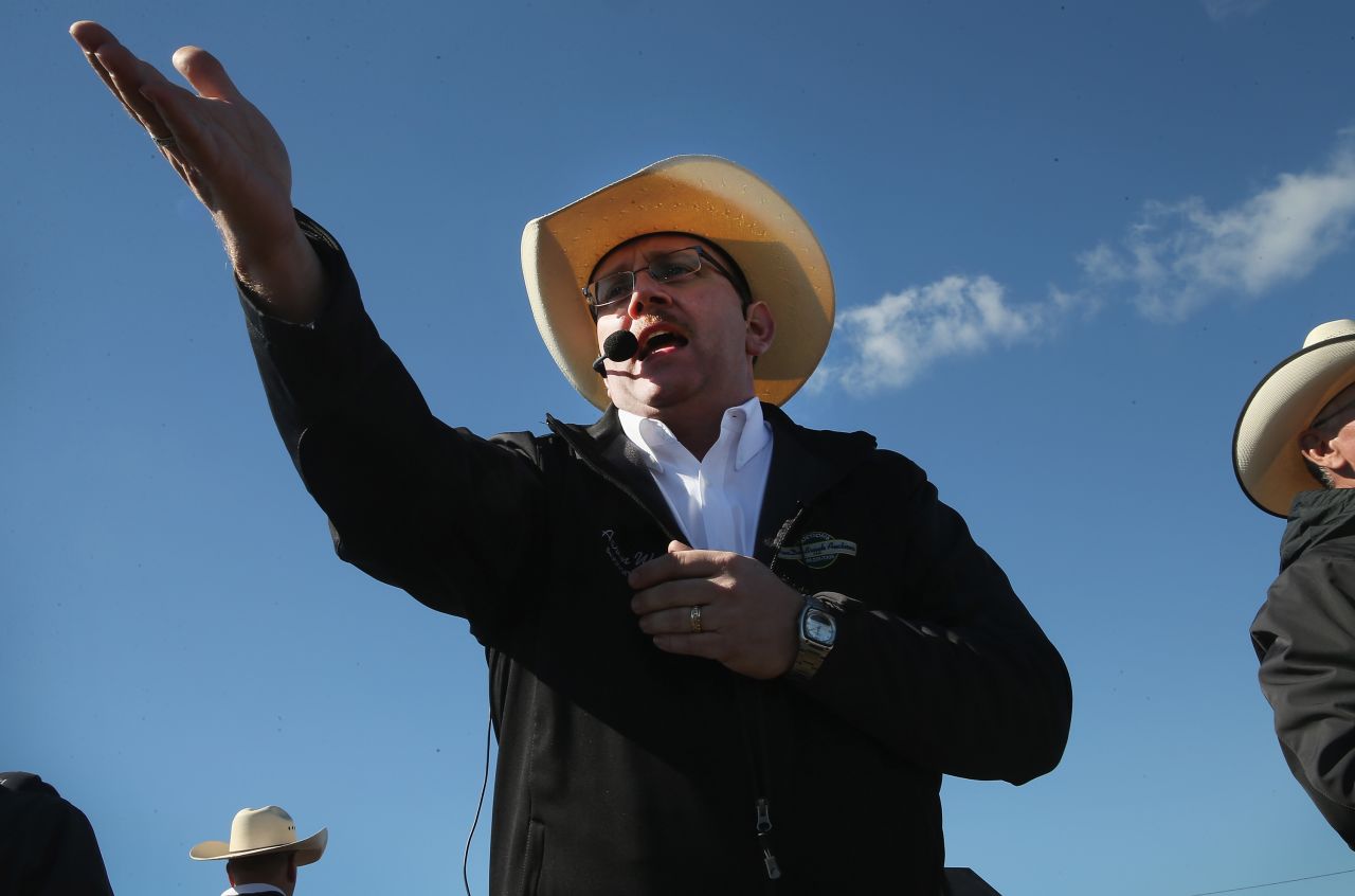 An auctioneer recognizes a bid at the Lambrecht family farm on Saturday.