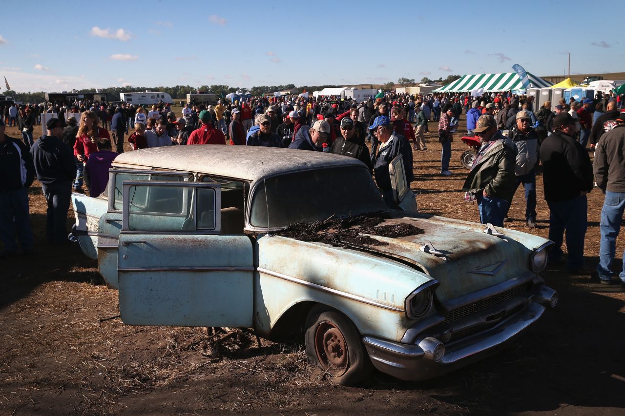 Potential buyers look over the selection of cars and trucks.