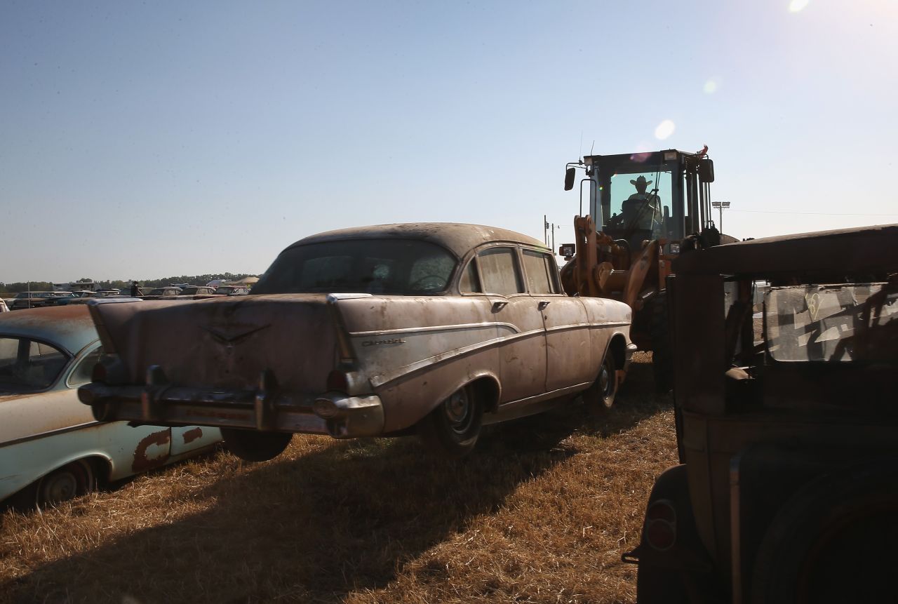 A worker positions a 1957 Chevrolet on the lot Thursday.