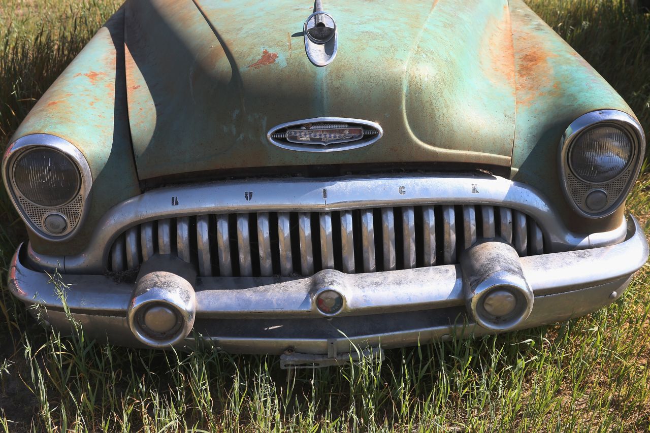 A Buick sits in a field ahead of the auction. The collection is made up of unsold cars from over the years.