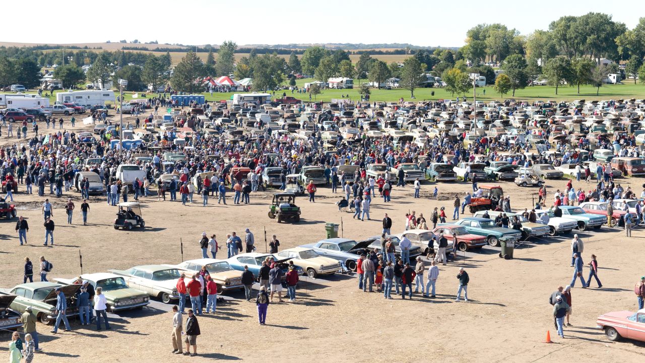 People explore the more than 500 classic cars from the Lambrecht Chevrolet Dealership in Pierce, Nebraska, on Saturday, September 28. The cars were auctioned off at the Lambrecht family farm over the weekend. 