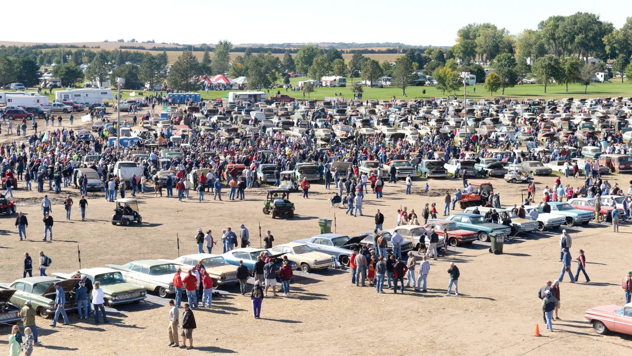 People explore the more than 500 classic cars from the Lambrecht Chevrolet Dealership in Pierce, Nebraska, on Saturday, September 28. The cars were auctioned off at the Lambrecht family farm over the weekend.