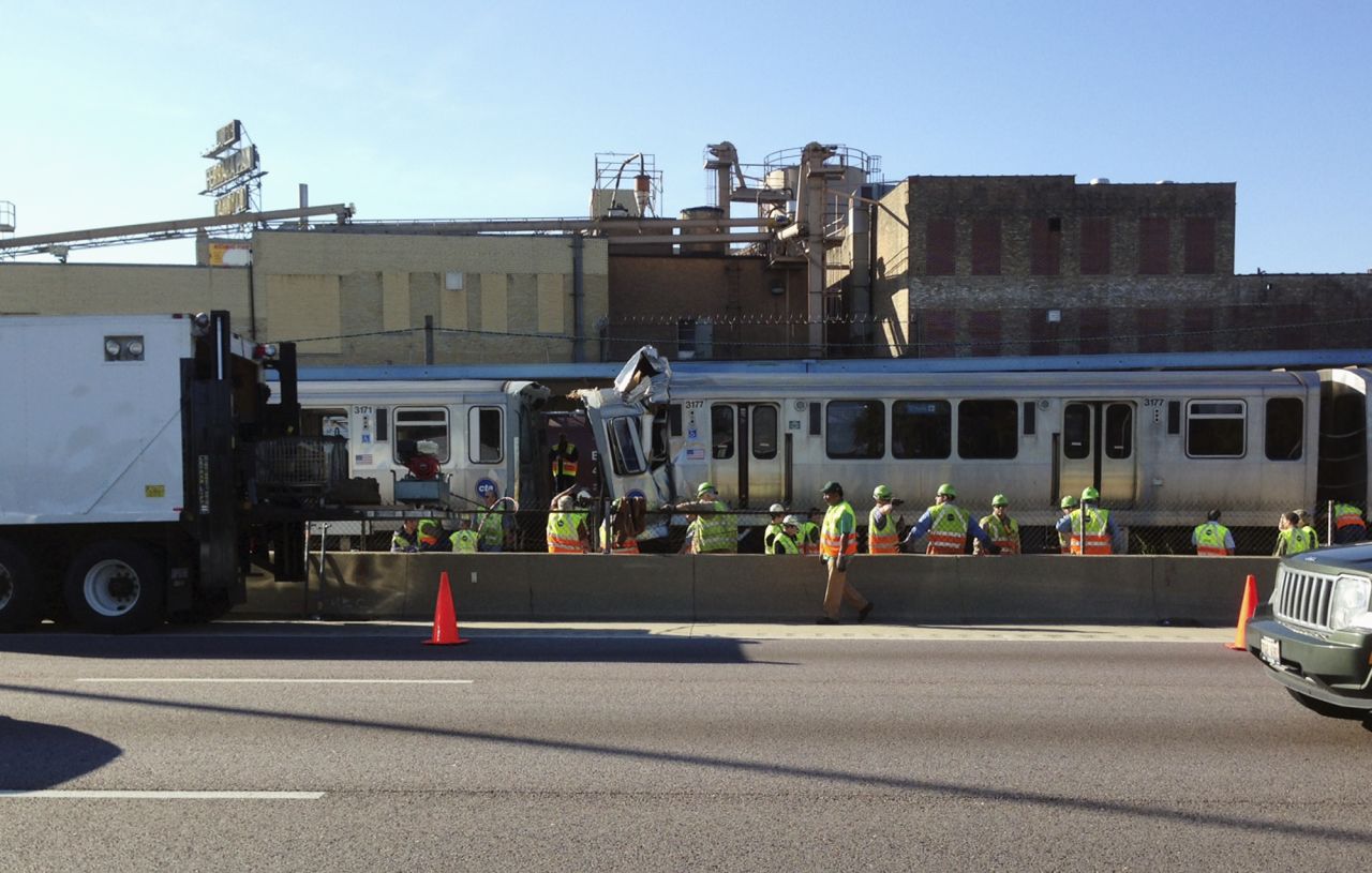 Emergency personnel investigate the scene on September 30 after a Chicago Transit Authority train ran head-on into another train that was stopped at a Blue Line station in Forest Park, Illinois.