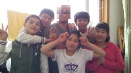 Young North Korean defectors pose for a photo with the South Korean missionary, known only as M.J. , a few days before they departed for the China-Laos border in May. M.J.'s face is obscured for his own safety.
