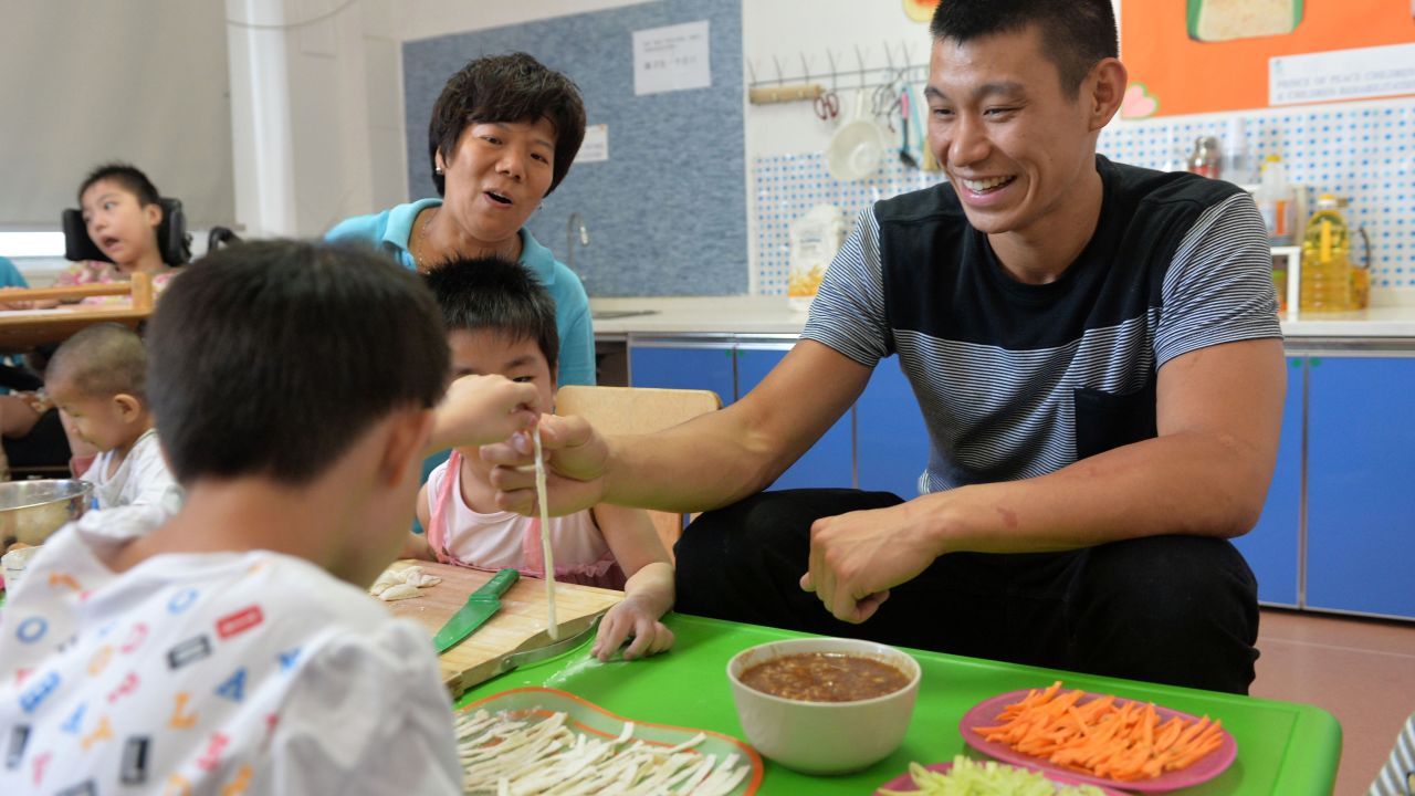 Lin makes noodles with children as he visits the Prince of Peace Children's Home and Children's Rehabilitation Center in Tianjin, China, in August. Lin said he would like to do Christian missionary work or nonprofit work when he's through playing basketball.
