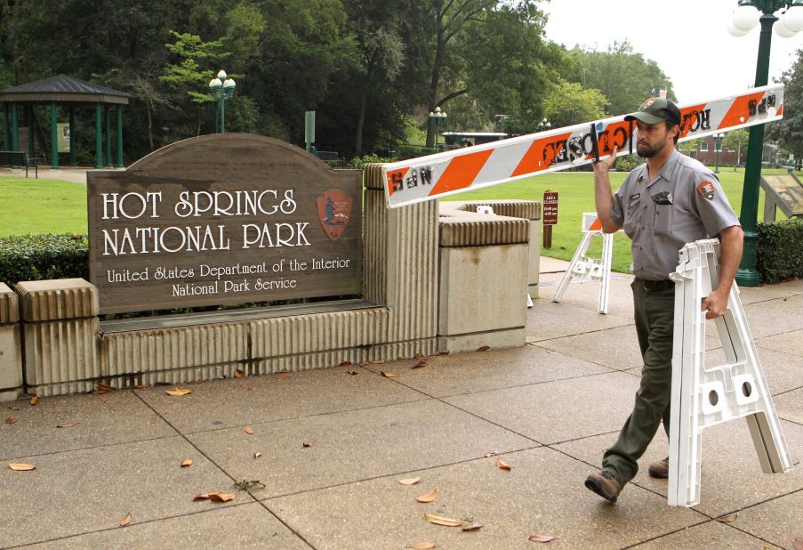 Hot Springs National Park employee Stacy Jackson carries a barricade while closing Arlington Lawn in Hot Springs National Park in Arkansas on October 1.