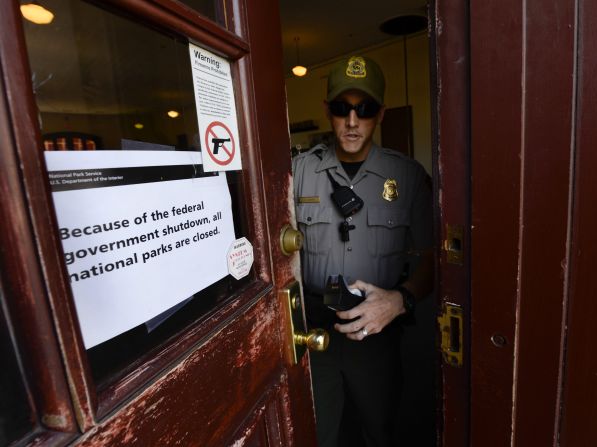A National Park Service ranger finishes putting up a sign indicating all facilities at the Martin Luther King Historic Site are closed to the public in Atlanta, on October 1.