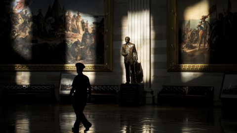 A U.S. Capitol police officer walks past a statue of Gerald Ford in the rotunda on Tuesday, October 1. The Capitol is closed to tours because of the government shutdown.