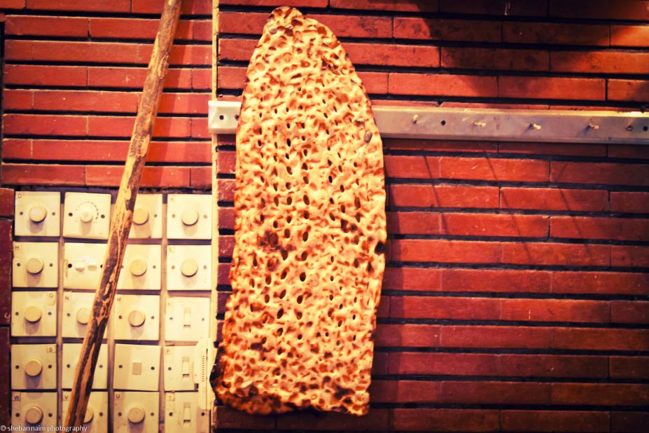 Crunchy Iranian sangak bread is fired on pebbles. It's eaten with feta cheese, lettuce and walnuts.