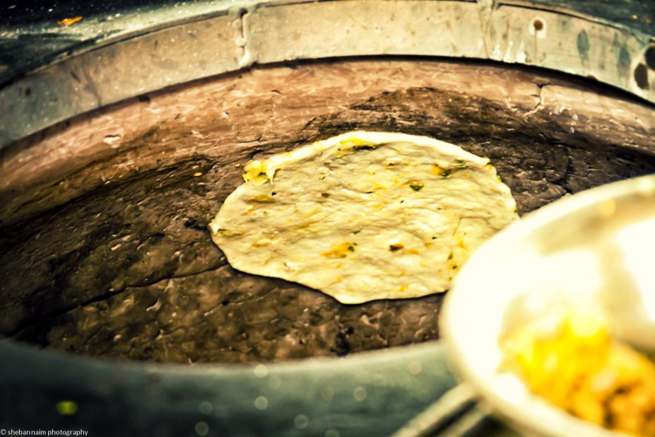 Punjabi stuffed kulchas (breads) are cooked in a traditional tandoor oven.