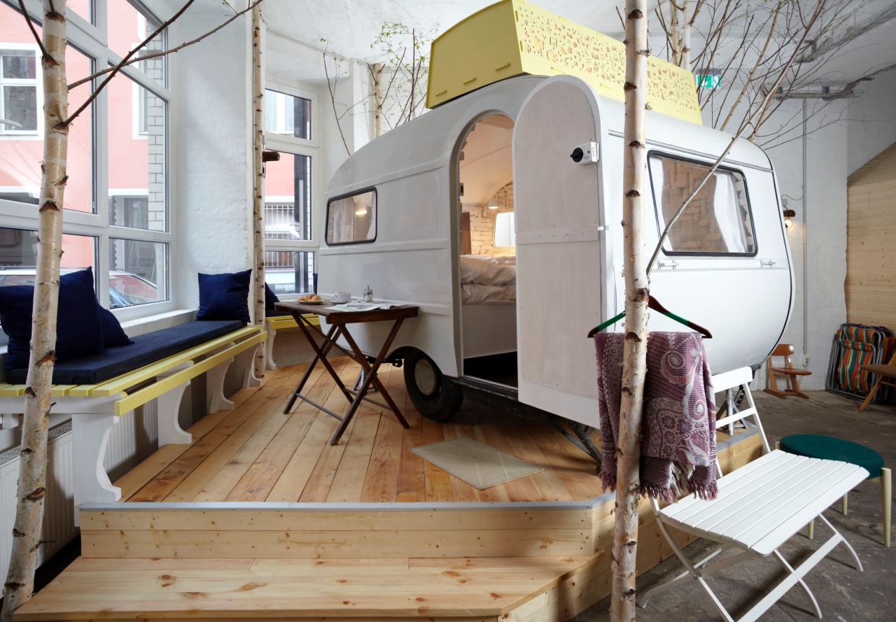 Housed inside a former vacuum cleaner factory, Hüttenpalast has a selection of fully furnished wooden huts and retro campers -- all under one roof. 
