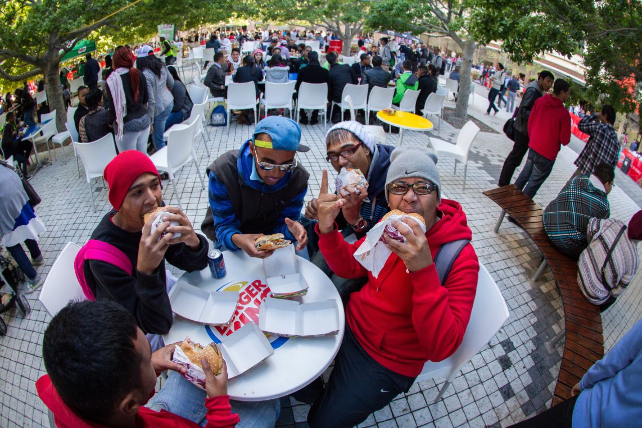 Fast-food fans tuck in to a first Burger King meal from the chain's Cape Town restaurant, which opened its doors in May 2013.