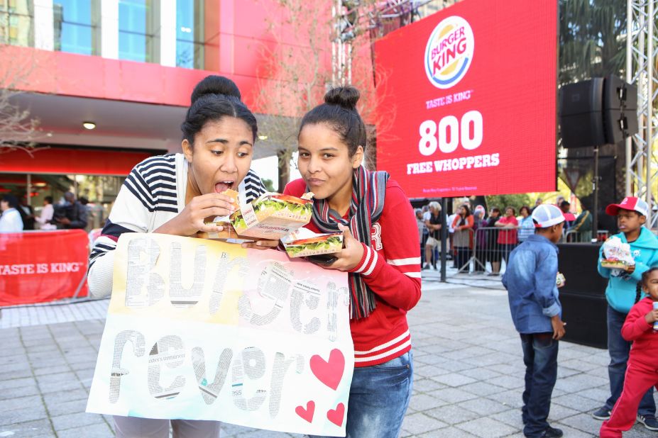 Girls tuck in to their lunches outside the Burger King in Cape Town.