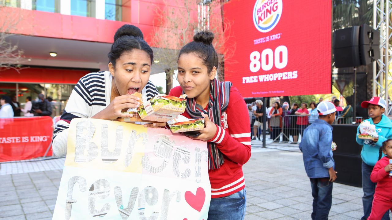 Girls tuck in to their lunches outside the Burger King in Cape Town.