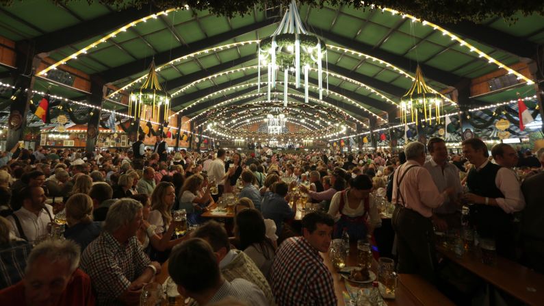 Visitors enjoy the evening at the Oktoberfest 2013 beer festival in Munich on Wednesday, October 2. Oktoberfest is the world's largest beer festival and runs September 21 through October 6.