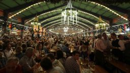 Visitors enjoy the evening at the Oktoberfest 2013 beer festival in Munich, Germany, on Wednesday, October 2.