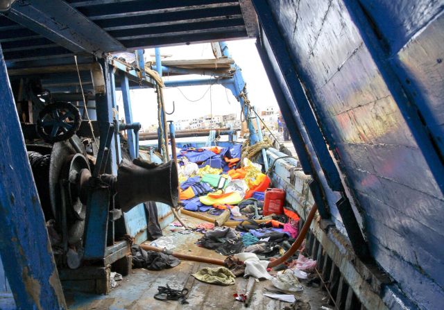 Migrants' belongings are scattered across the deck of a ship on October 3.