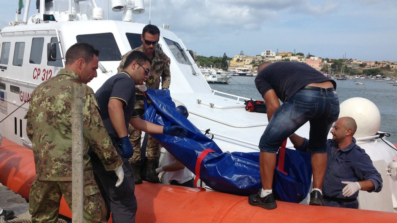 The body of a drowned migrant is unloaded from a Coast Guard boat in Lampedusa in October 2013.