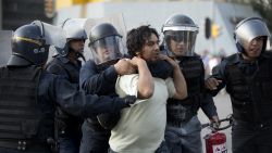 Riot police arrest a demonstrator in Mexico City on October 2, 2013. Mexican students marched Wednesday to commemorate the anniversary of the Tlatelolco massacre of university students. AFP PHOTO/ YURI CORTEZ (Photo credit should read YURI CORTEZ/AFP/Getty Images)
