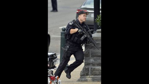 A police officer runs after reports of shots being fired.