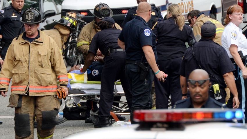 Emergency personnel put an unidentified police officer on a stretcher.