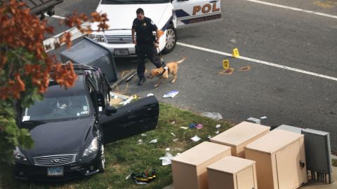 A police officer and K9 inspect the scene after a car chase and reports of gunshots fired outside of the Hart Senate Office Building on Captiol Hill on Thursday, October 3 in Washington. Police said the U.S. Capitol was put on security lockdown.
