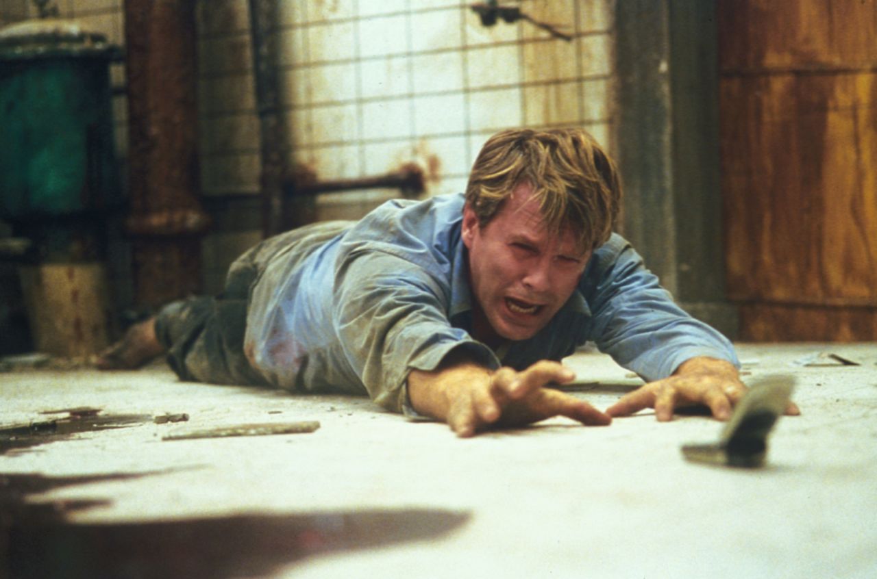 For almost the entire running time of "Saw" (2004), a corpse lies in a pool of blood on the floor of well-hidden washroom. Meanwhile, two chained figures, played by Cary Elwes and Leigh Whannell, realize they're part of a brutal serial killer's game. After much gore and misdirection, the serial killer is revealed to be the corpse -- who's not so dead after all.