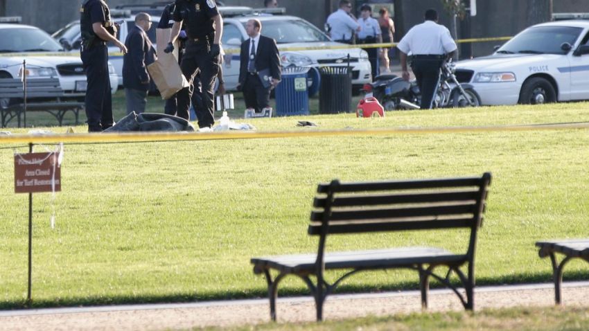 Police investigate the scene after a man set himself on fire at the National Mall on October 4 in Washington.