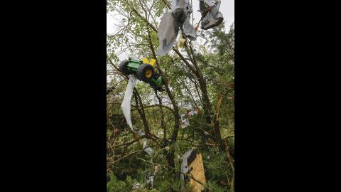 Debris, including a toy tractor, hang in a tree following a tornado in Hickman, Nebraska, on October 4.