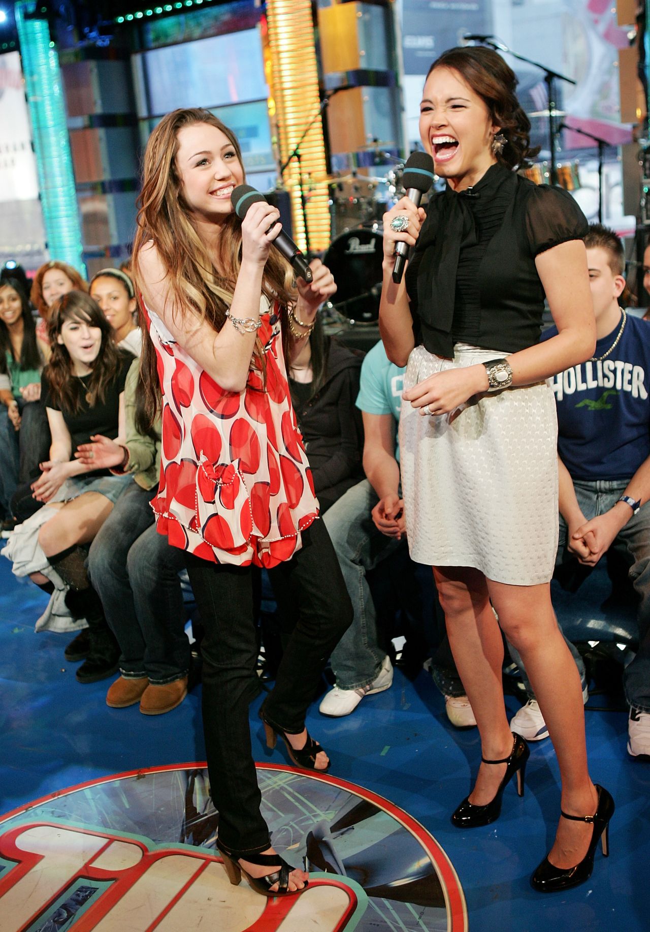 Cyrus chats with VJ Susie Castillo during an appearance on MTV's Total Request Live in February 2007 at MTV Studios in New York City. 