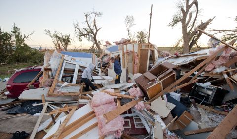 Matt and Traci Krus salvage items from their tornado-damaged home on October 5 in Wayne, Nebraska. 