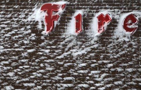 Snow is plastered on to the side of the Firestone sign in downtown Rapid City, South Dakota, on October 5. 