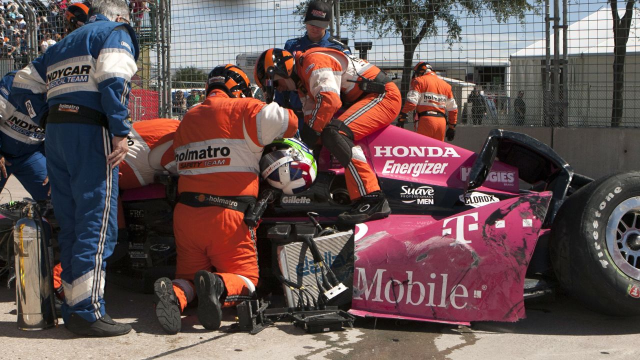 Safety team members work to remove Dario Franchitti of Scotland from his car after a crash during the second IndyCar Grand Prix of Houston auto race, Sunday, Oct. 6, 2013, in Houston. (AP Photo/Juan DeLeon)