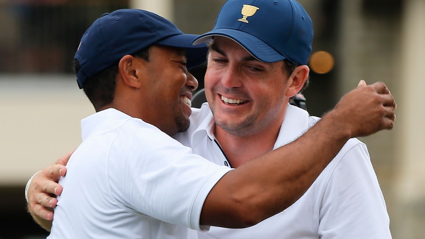 Keegan Bradley, right, congratulates Tiger Woods after his U.S. teammate secures victory in the Presidents Cup in Ohio. 
