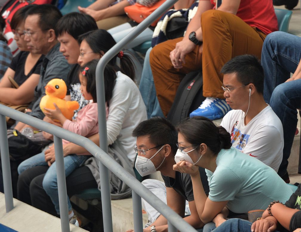 Spectators at the China Open also took to wearing the masks courtside over the weekend, such as this couple watching one of the women's semi-finals Saturday.