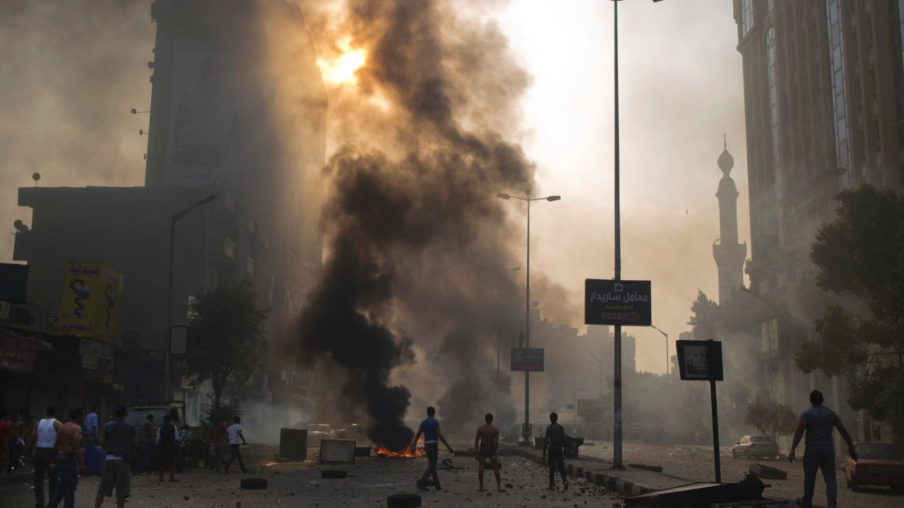 Supporters of ousted Egyptian President Mohamed Morsy clash with security forces in Cairo on Sunday, October 6. Protesters of the military-backed interim government took to the streets around the country, leaving more than 50 people dead and more than 260 injured, according to state media.